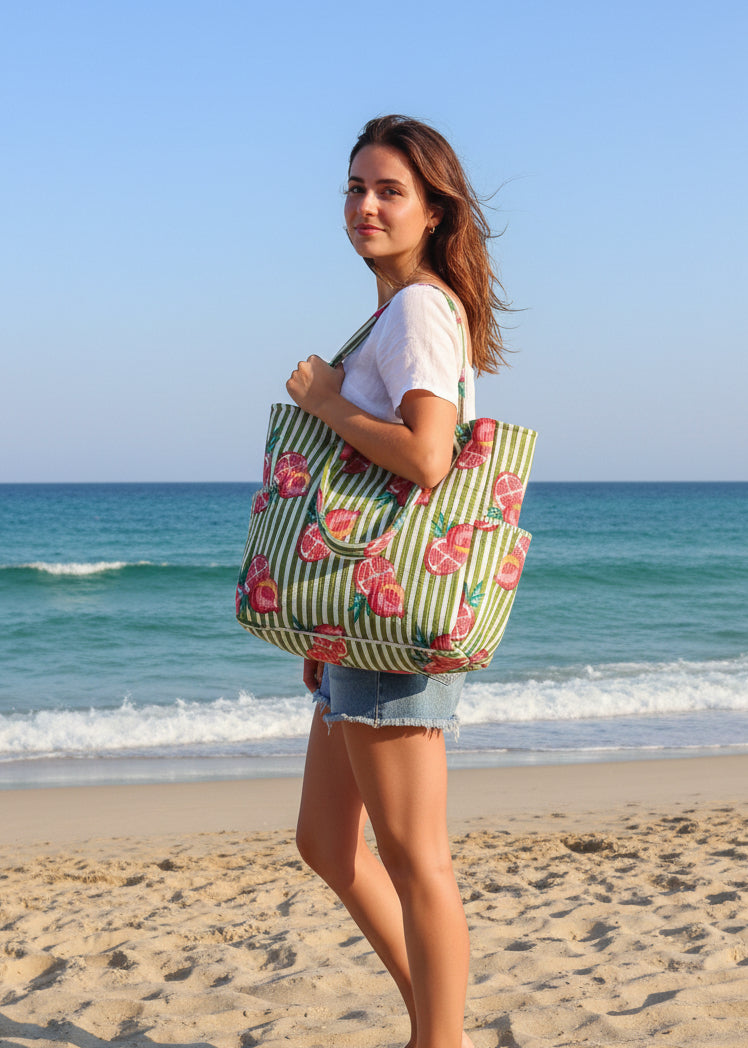 Fabric bag with pomegranate pattern on a green striped background